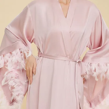 Pink robe with feather-trim sleeve and tied waist